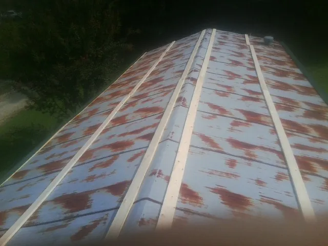 Rusted metal roof panels with new wood purlins before replacement — Storm Damage Roof Repair in Oroville by Roofing Brothers